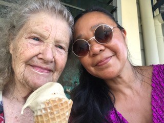 Young woman and senior lady having ice cream together